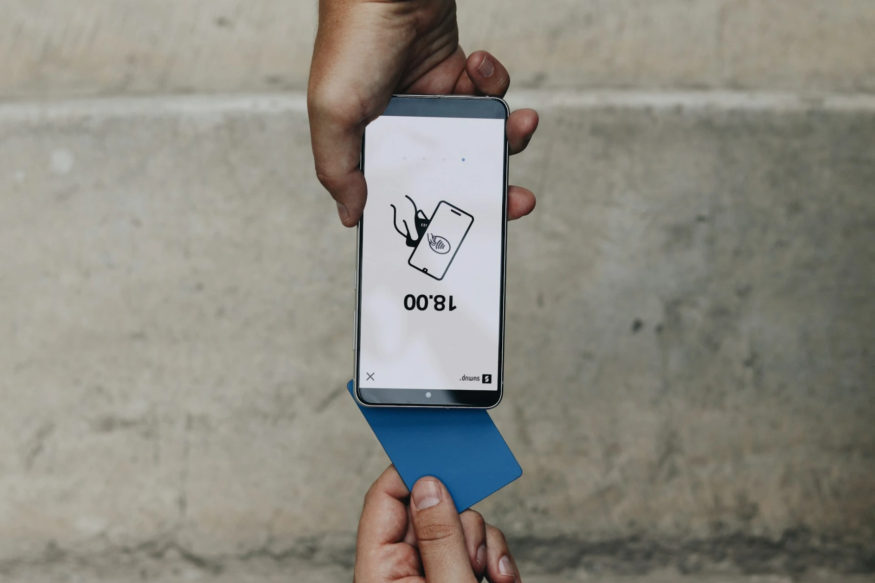 A person holding a box with a cat on it